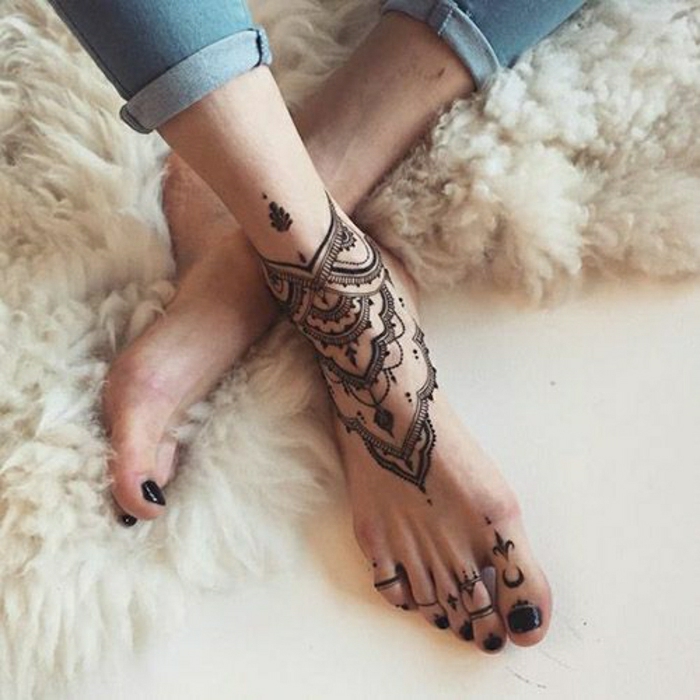 черна глезена и пръсти татуировка, жена с дънки и черен лак за нокти на пръстите си