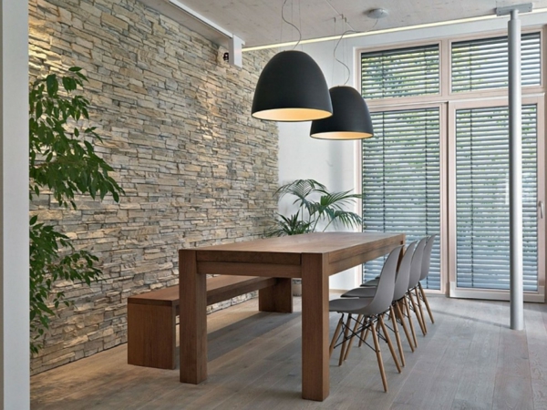 muro de piedra natural en las lámparas de la sala de estar y mesa