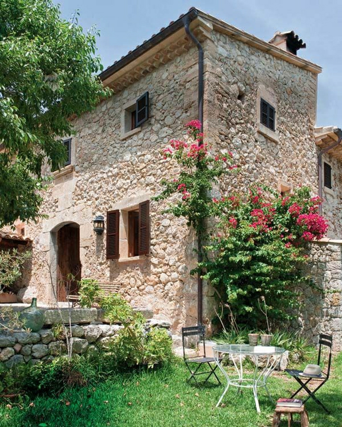 Steinhaus Villa de style méditerranéen jardin de fleurs vert-rose fer forgé chaises