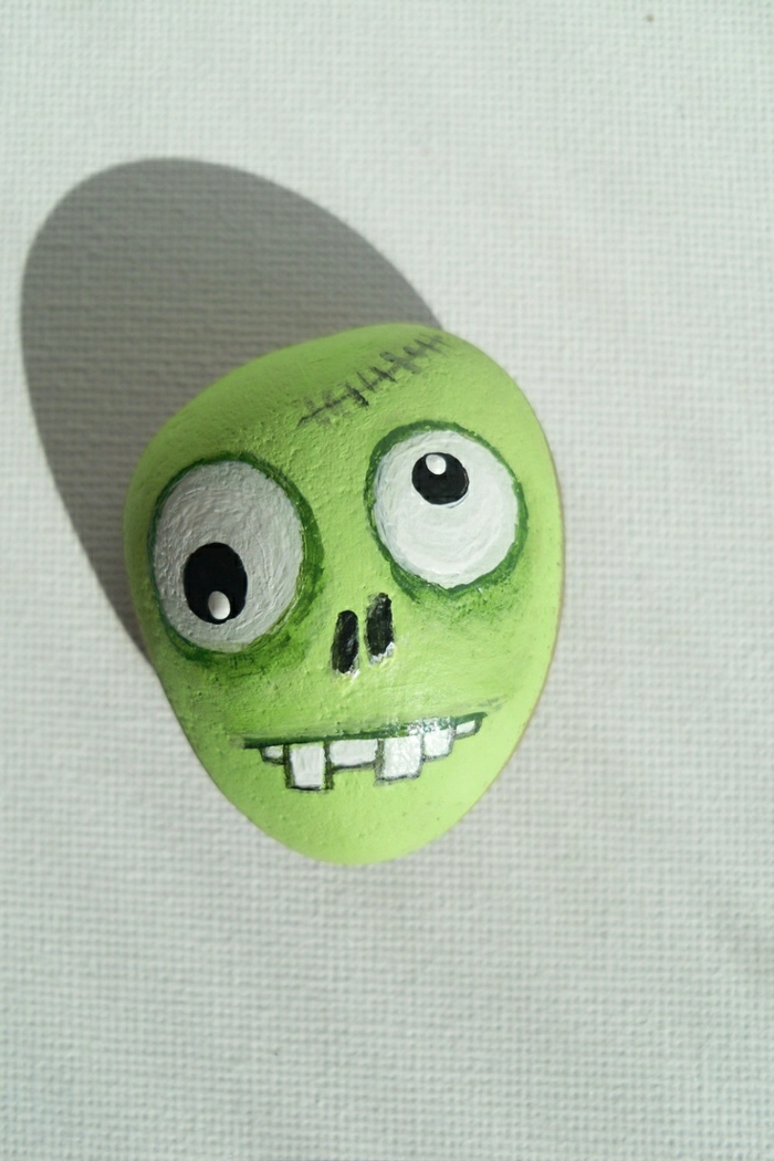 maalattu kivi kauhea piirtäminen Zombie asukasta vihreä