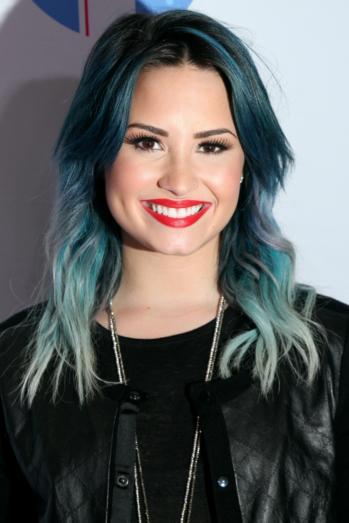 Kék haj, Demi Lovato, élénk piros ajkak, fekete szemceruza és szempillaspirál, fekete bőrdzseki
