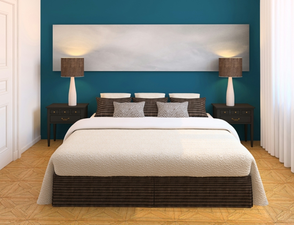 طلاء الجدار الأزرق وسرير أبيض في غرفة النوم