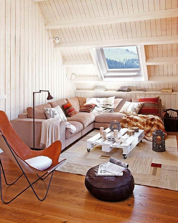 Sofa s mnogo šarenih jastuka u krovnoj sobi