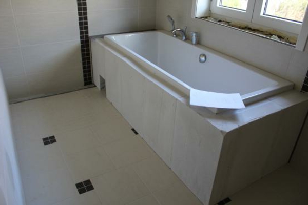 deco-tiled-bathroom-modern-bathtub-tile - window next to it