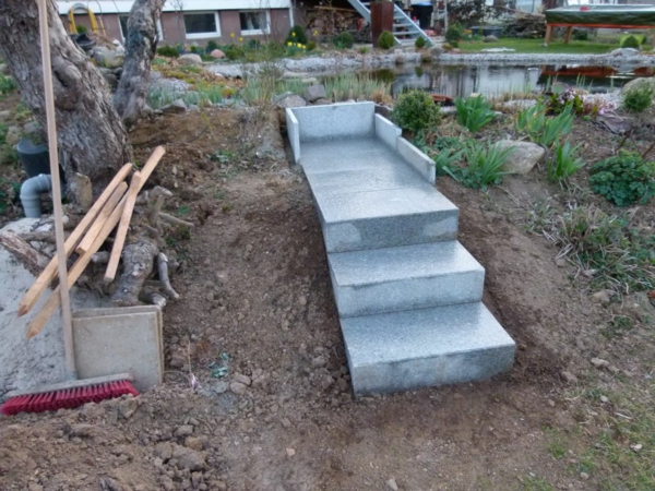 a-small-stairs-self-build-in-process- al lado de un estanque