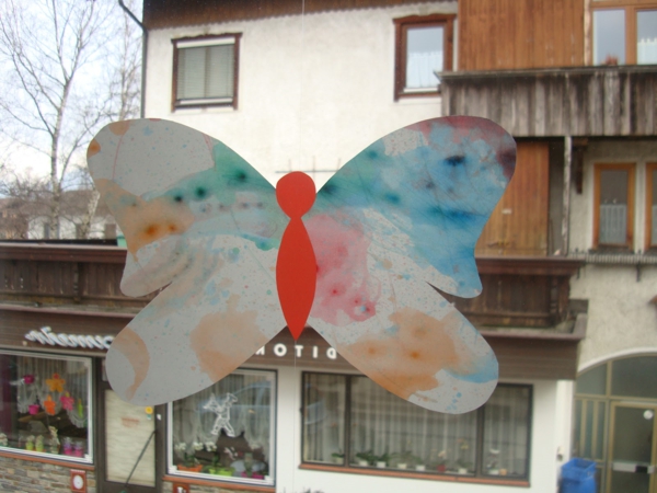 Kevään koristelu - lapsilla-perhosia-ikkunalla