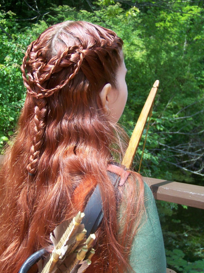 لون الشعر الأحمر ، القوس والسهام الضفائر الجميلة المعقدة ، واللباس الأخضر