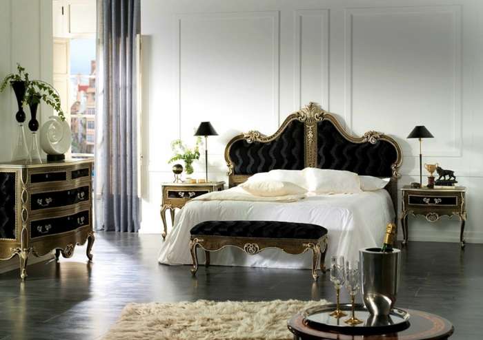 голяма спалня с двойно легло в готически стил, готически чекмеджета в черно и златисто, почти бял килим