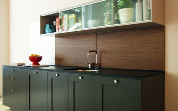 кухня с дървена задна стена и черни кухненски шкафове